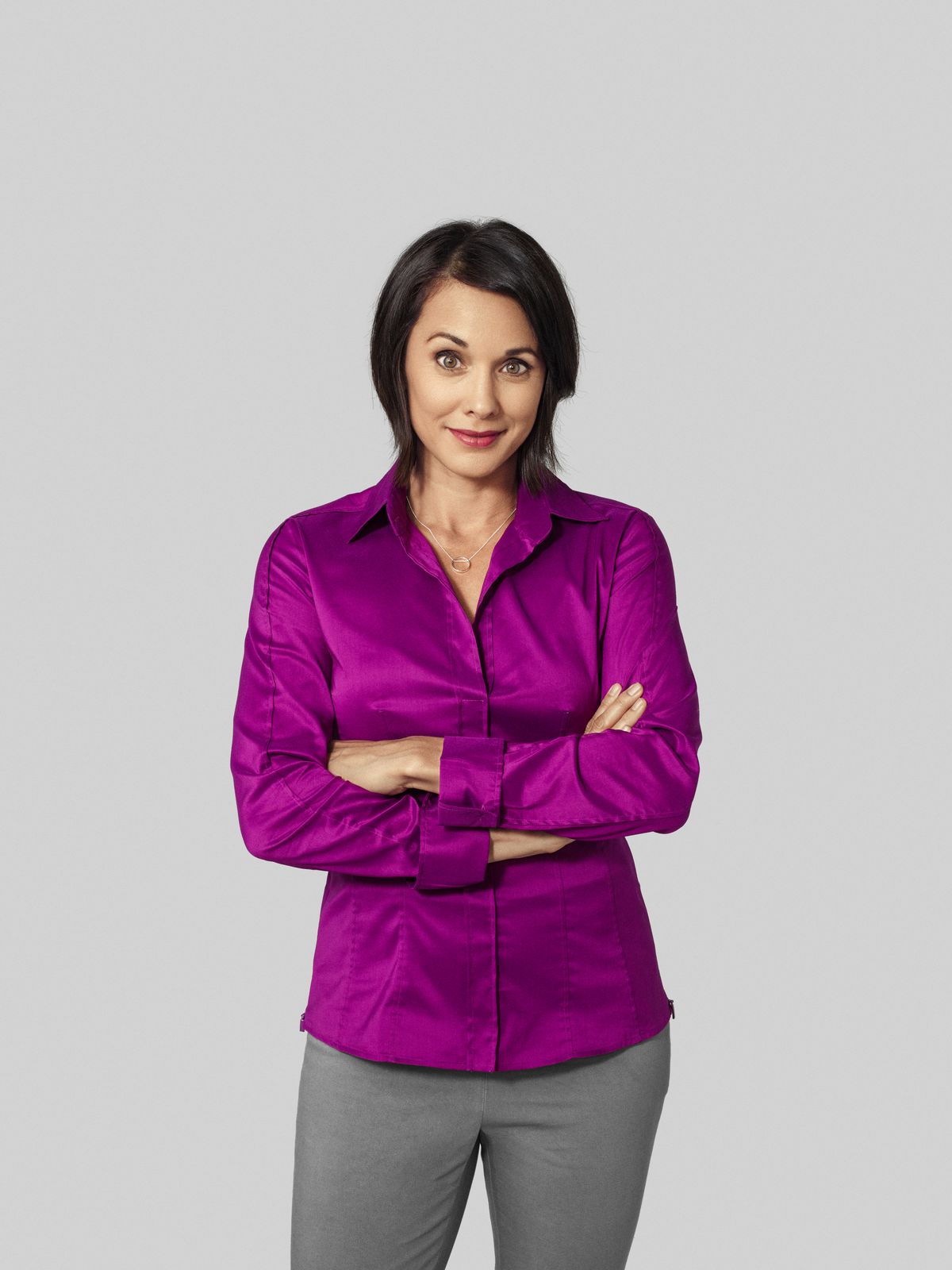 Woman in purple shirt looking at camera