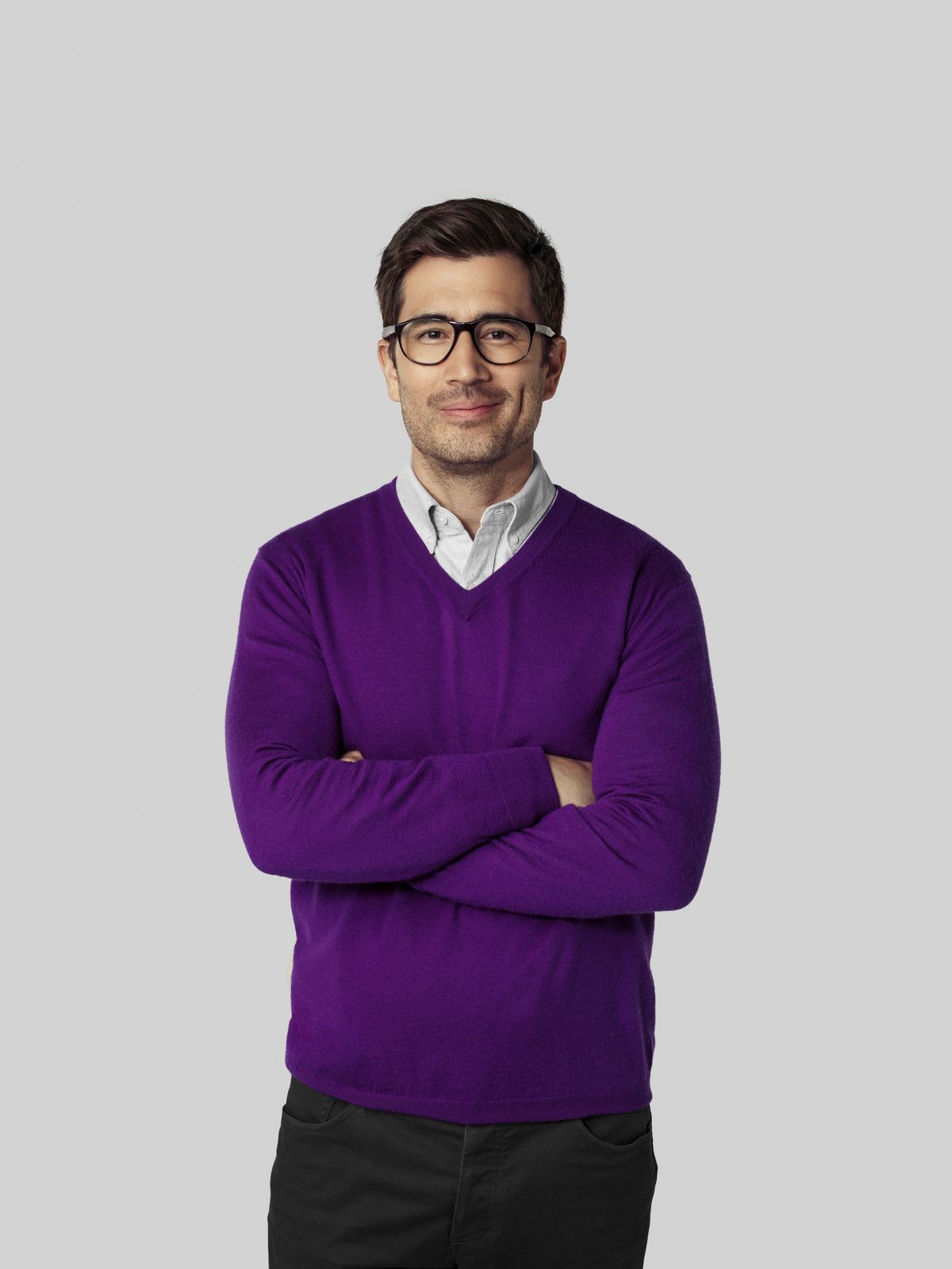 Man in purple sweater looking at camera