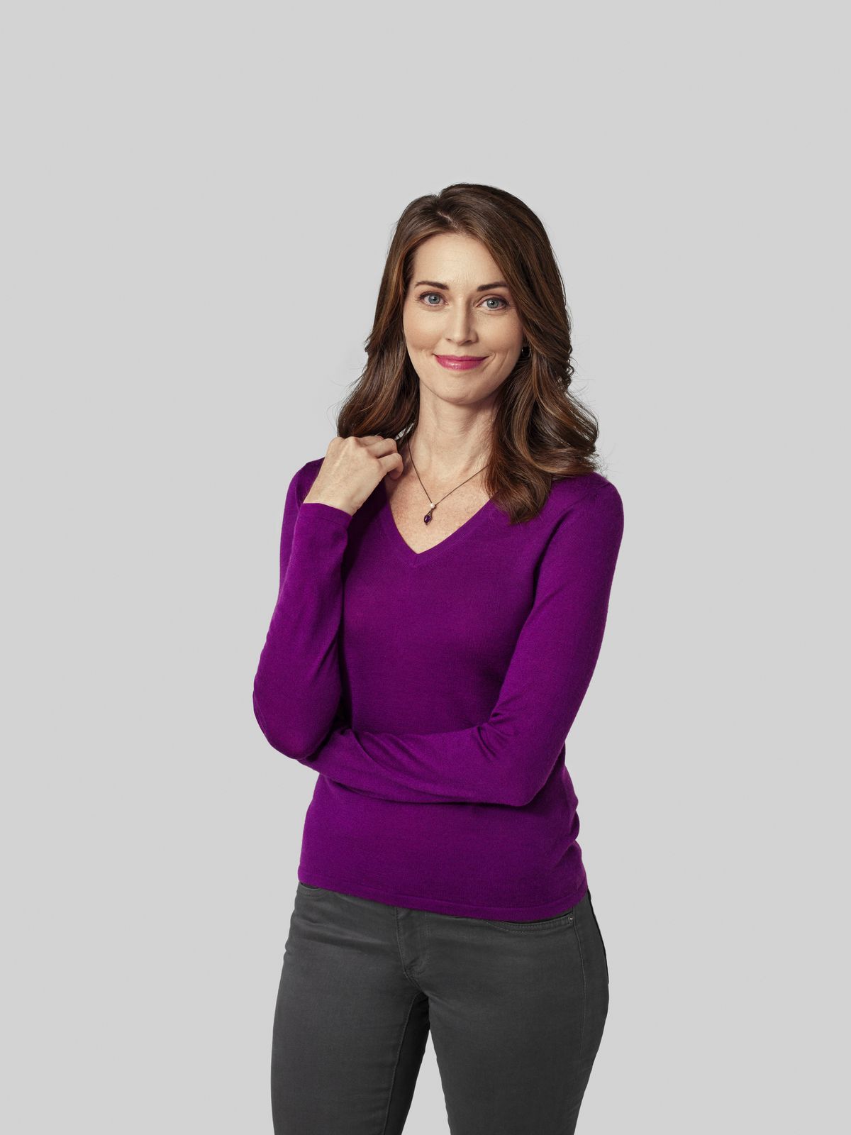 Woman in purple sweater looking at camera